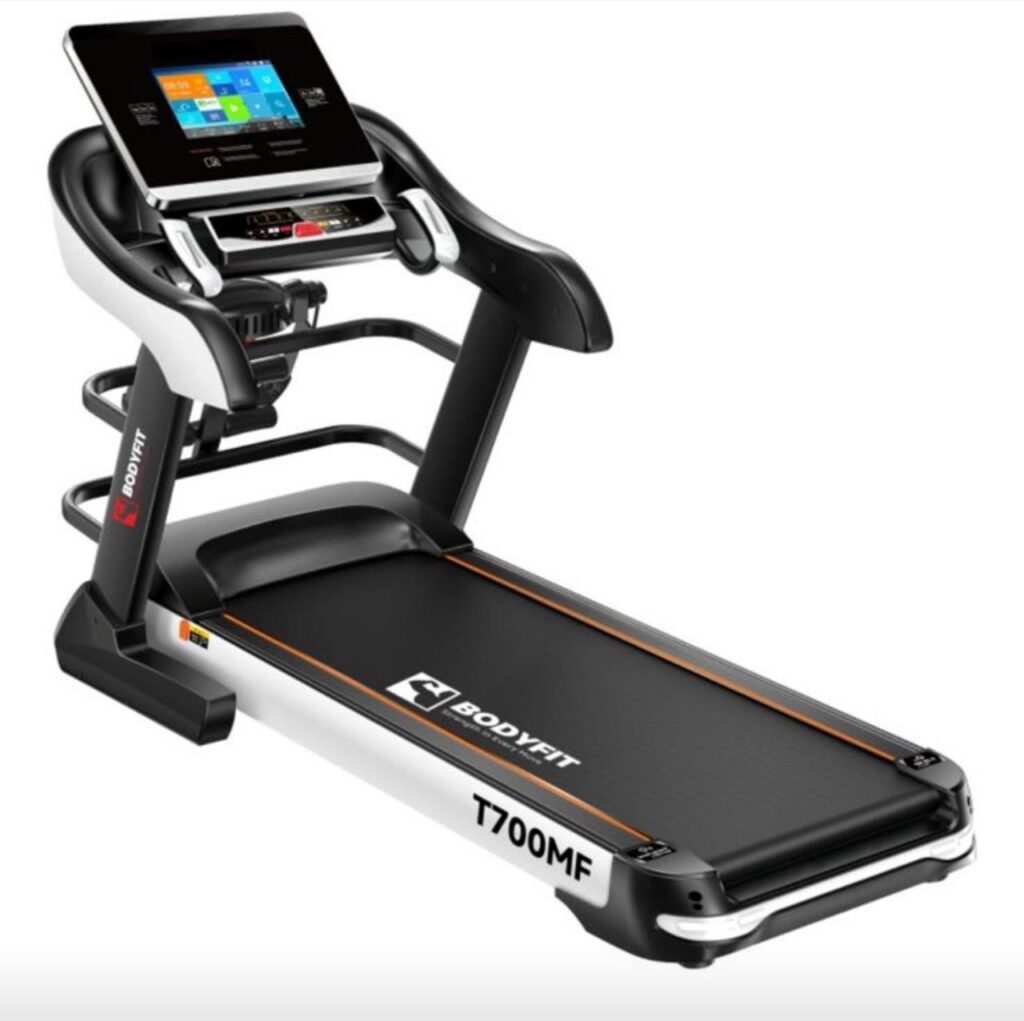 Front-right view of a Delight T700MF treadmill featuring a large touch display and ergonomic handrails